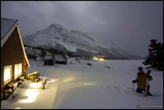 - Many Glacier Cabin and Winter Caretaker, with Allen Mtn Under Moonlight Behind, Glacier NP -
