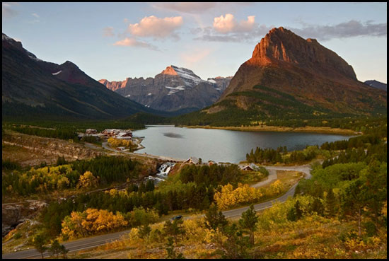 - First Light on Mt. Gould and Grinnell Point, with Swiftcurrent Lake, Many Glacier Hotel and Aspens in Fall Color Below, Glacier NP -