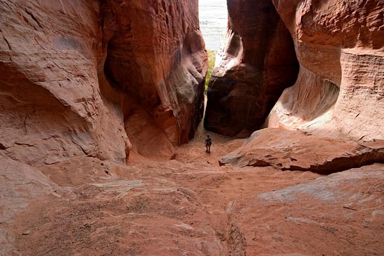 - Hiker Inside a Cave in Cave Knoll, Lower Kolob Plateau, Zion NP -